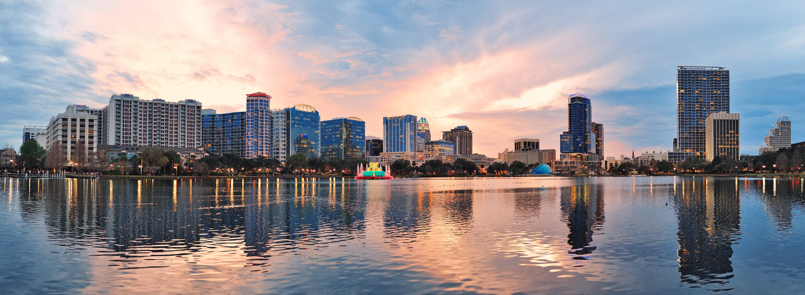 Orlando downtown Lake Eola panorama with urban buildings and reflection